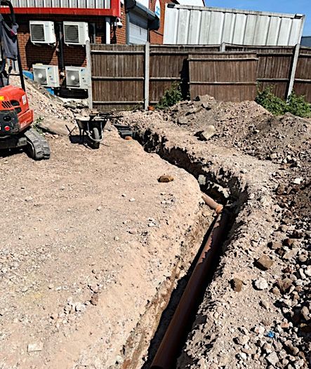 Excavated trench for new drainage pipework