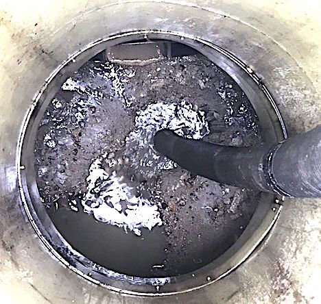 Interceptor chamber being emptied by vacuum hose